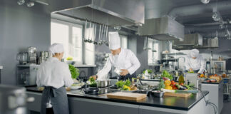 Big and Glamorous Restaurant Busy Kitchen, Chefs and Cooks Worki